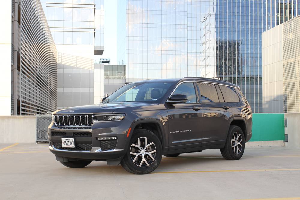 Grey Jeep Grand Cherokee parked on a rooftop deck