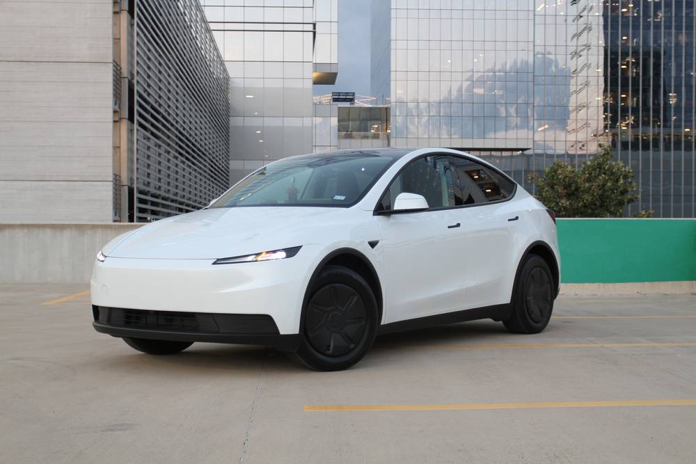 White Tesla Model Y parked on a rooftop deck in Austin